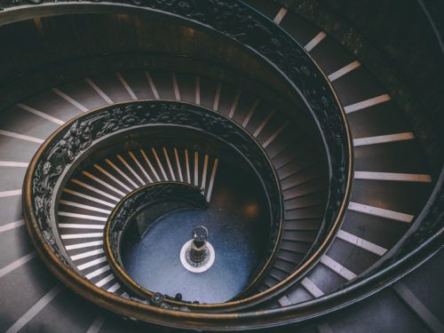 A view from the top of a spiral staircase looking down