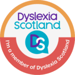 Circular badge design in coral and ochre with the Dyslexia Scotland logo. Text reads 'I'm a member of Dyslexia Scotland'.