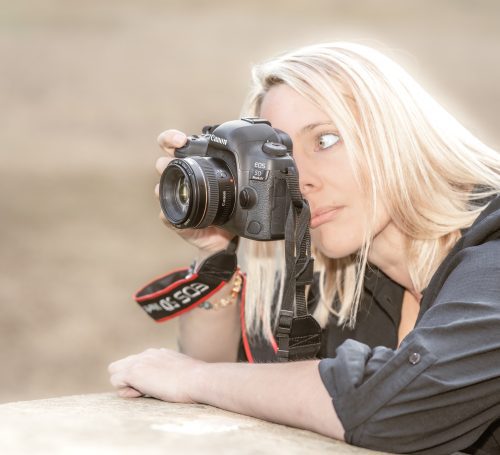 Annie Rees holding her camera to her eye