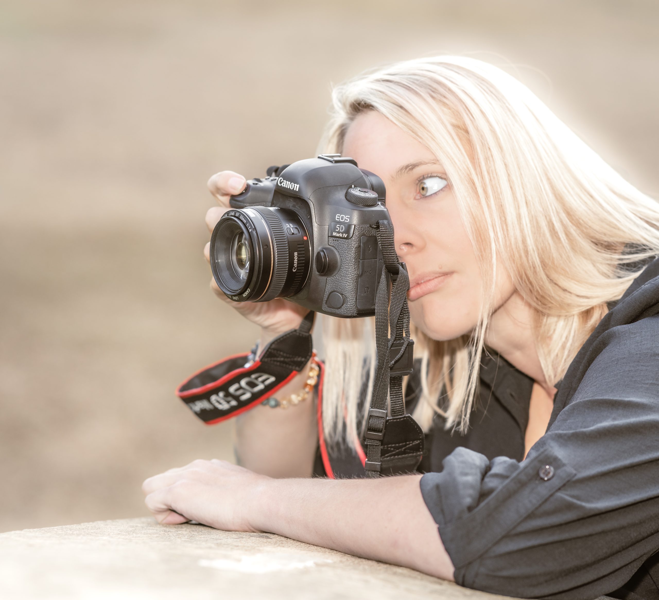 photographer Annie Rees looks through her camera