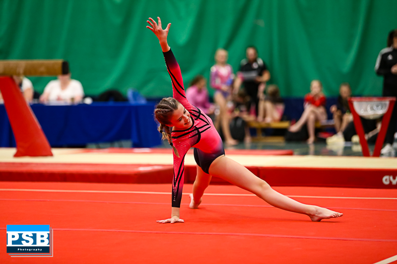 A young gymnast takes part in a competition.