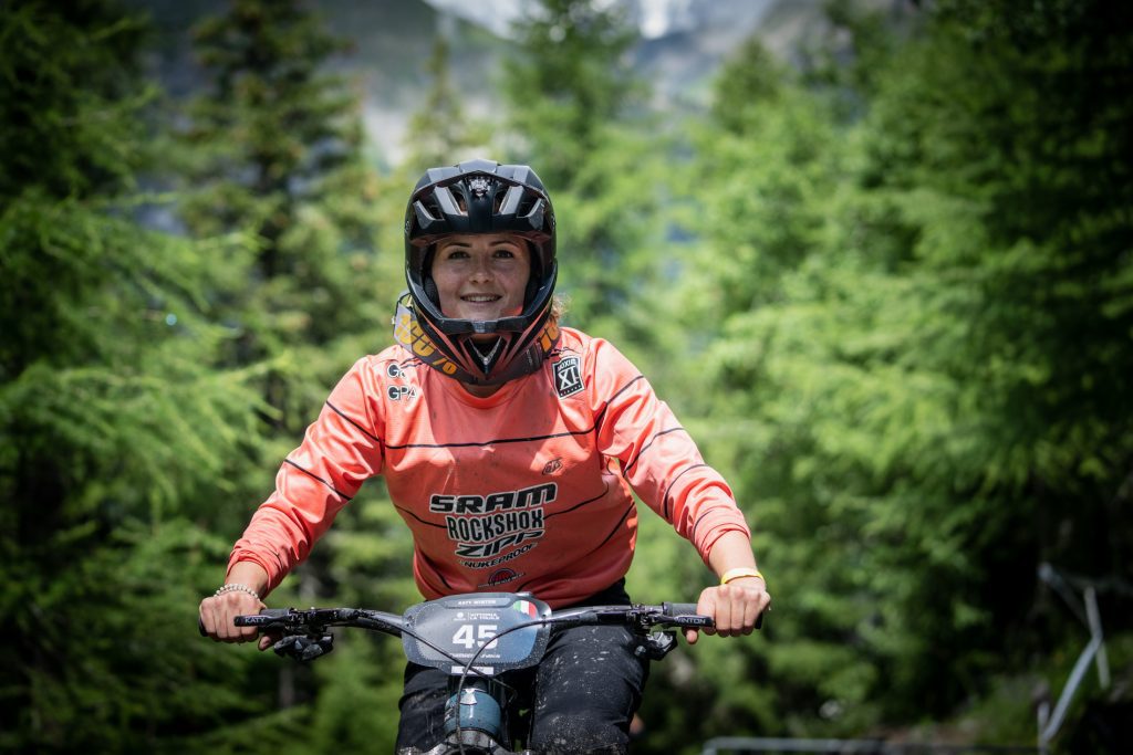 Photo of Katy sitting on her mountain bike
