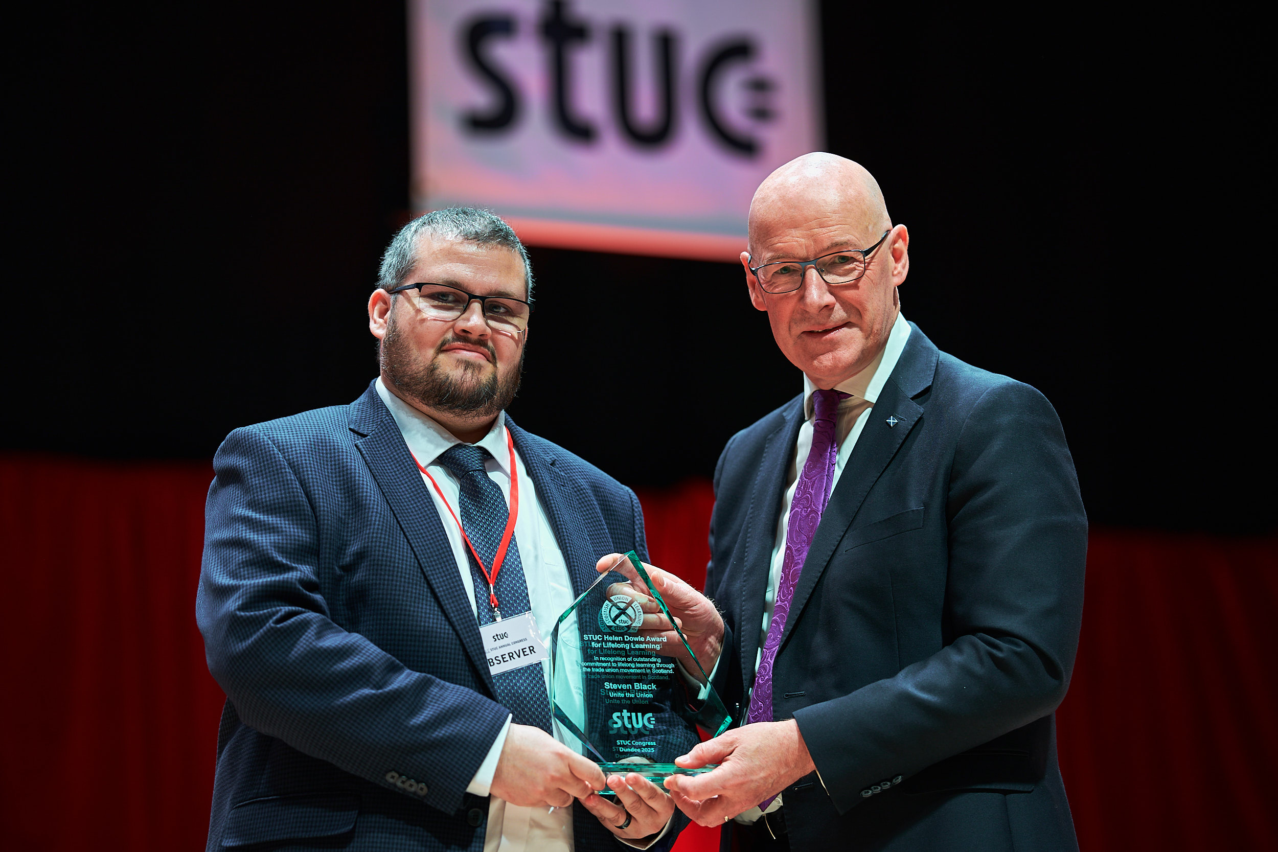 First Minister of Scotland John Swinney presents Steven with the Helen Downie award