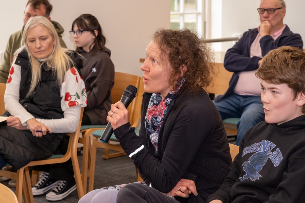 Audience member speaks into microphone