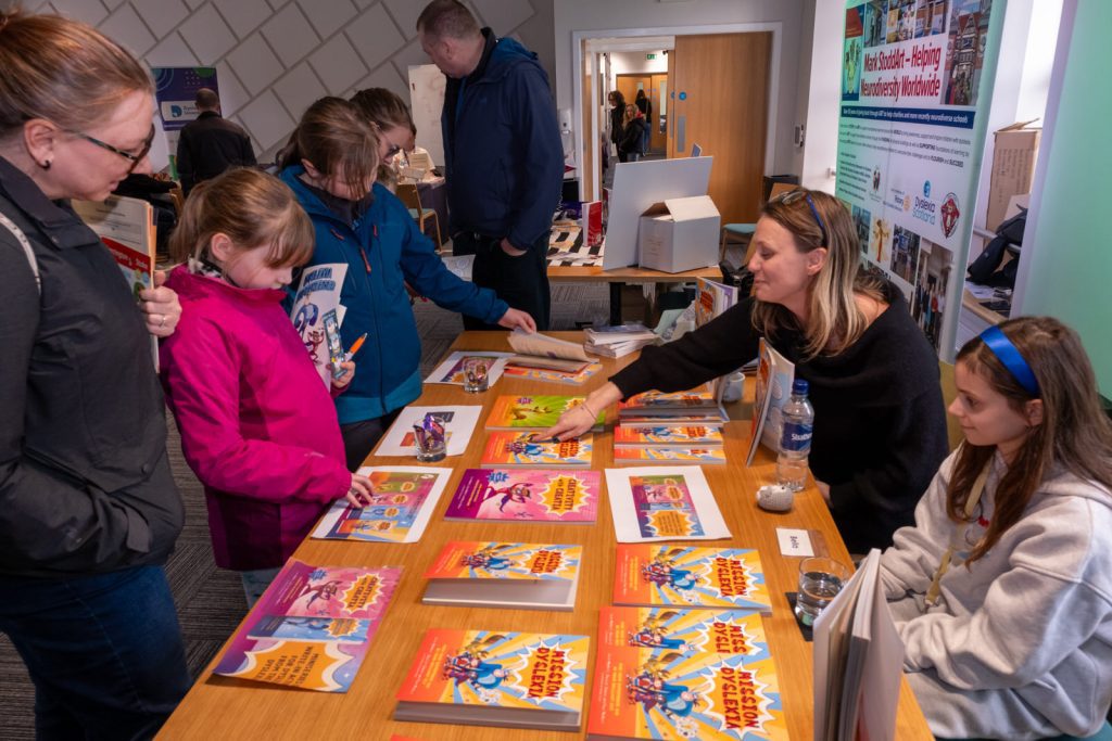 A crowd gathers at a book stall