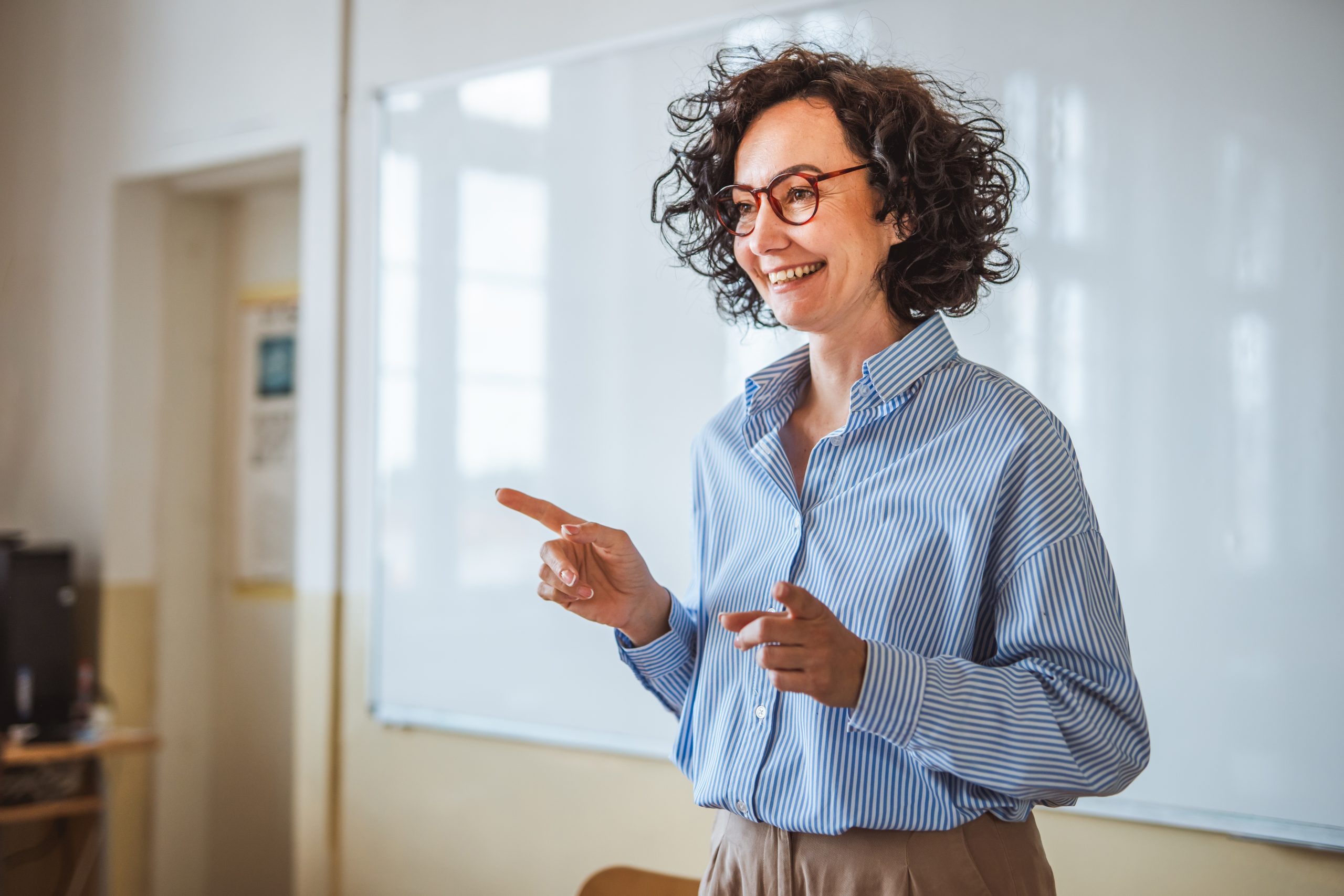 A lecturer smiles and addresses her students
