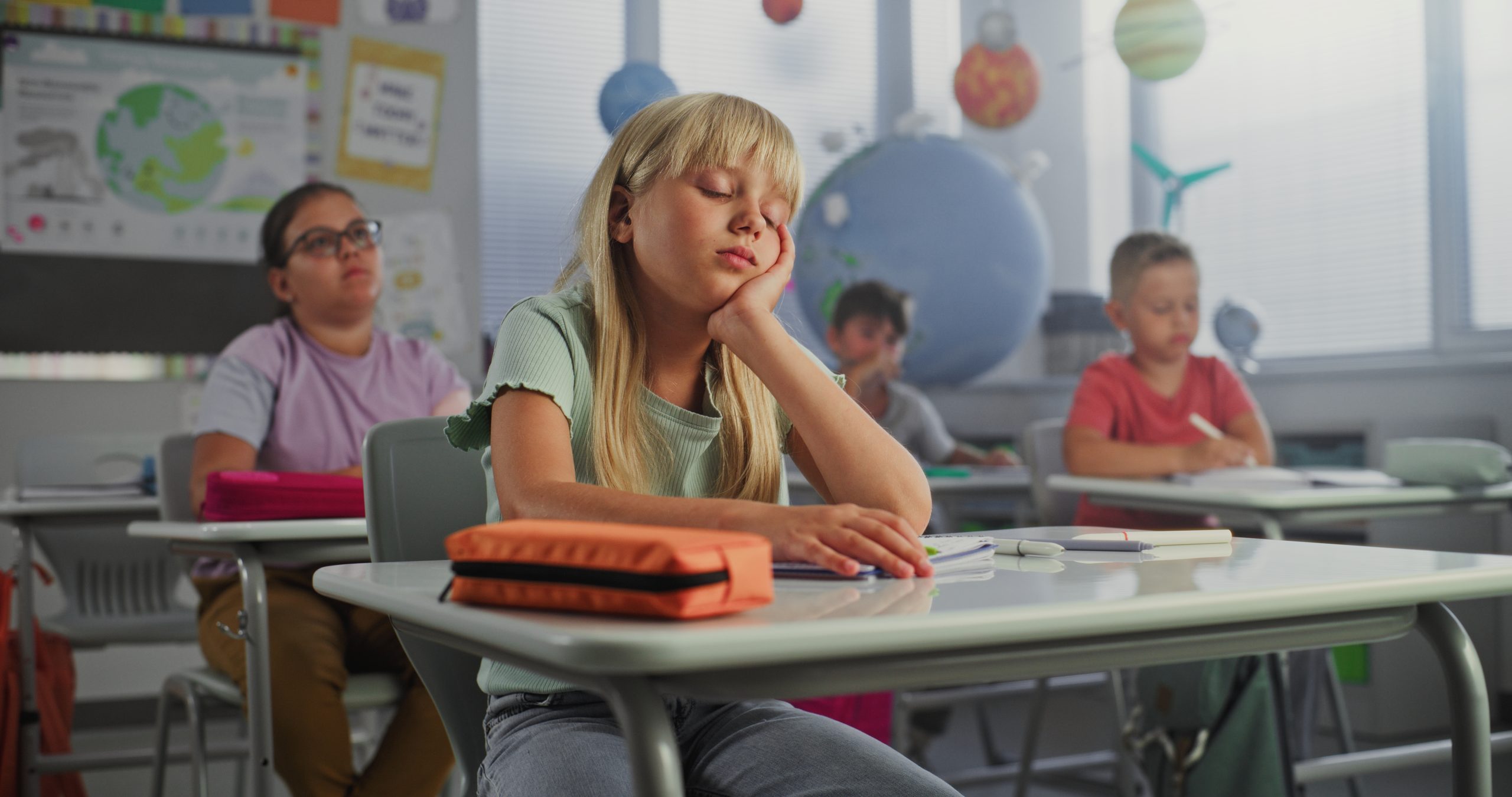Sad ooking young girl in primary school classroom