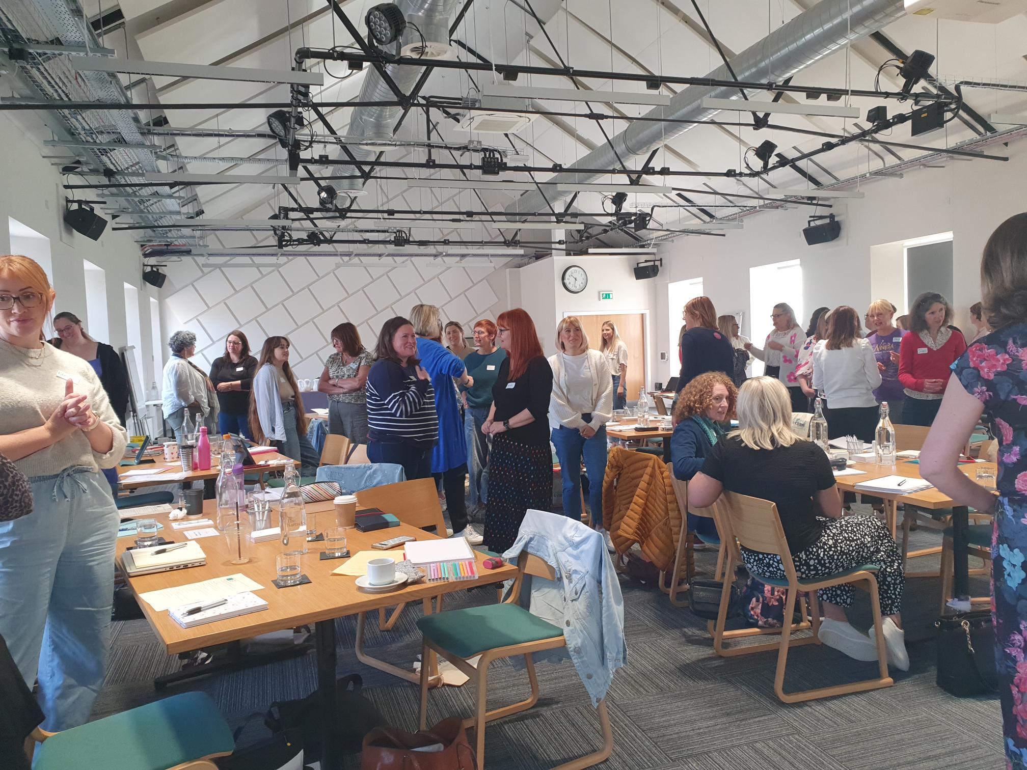 Teachers in a training space, interacting