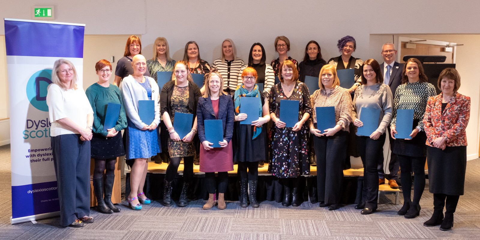 A group of teachers hold certificates for their training in dyslexia and inclusive practice.