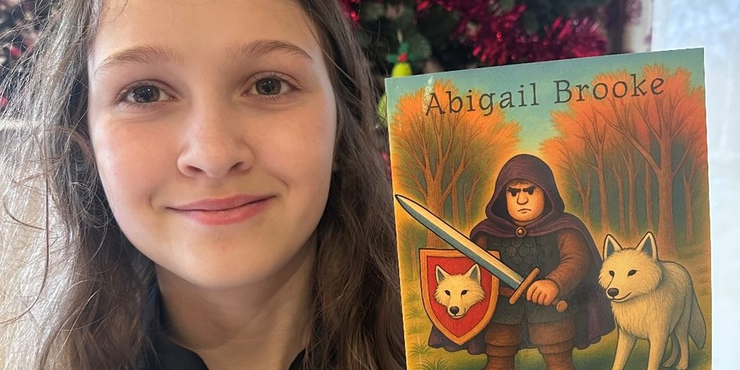 Abigail with her book Wolf and Wolf Warrior