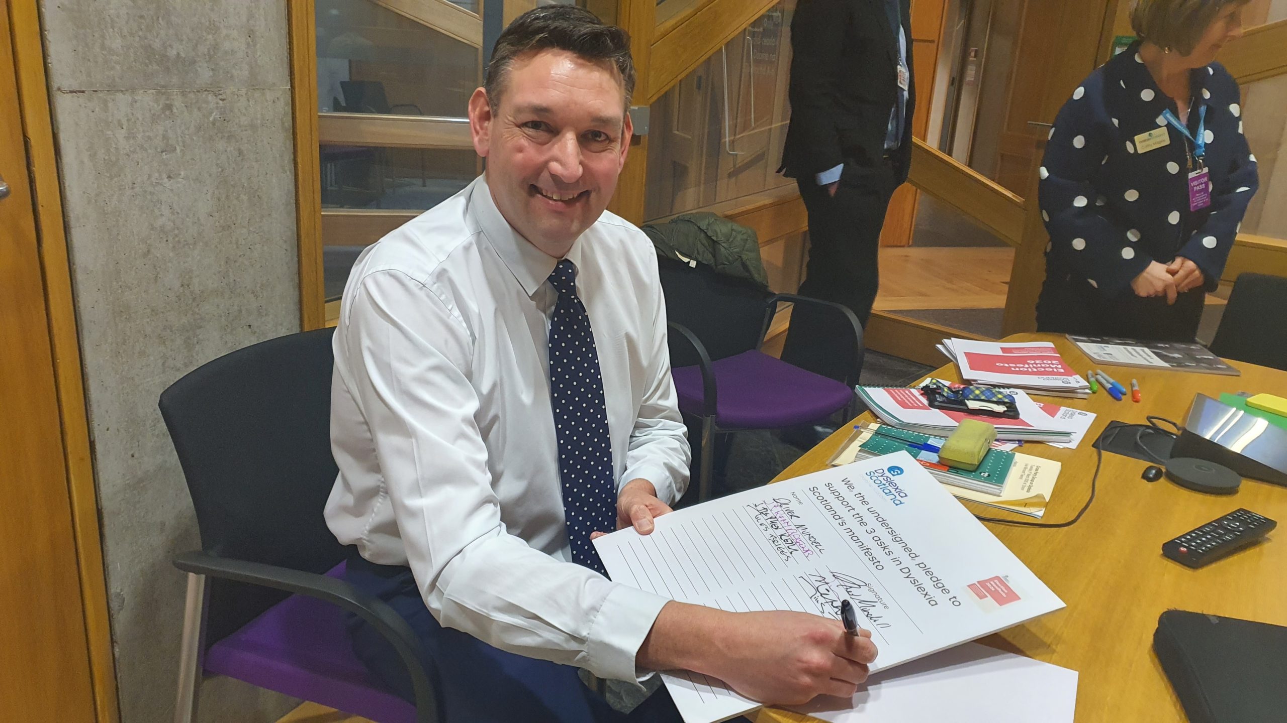 Miles Briggs MSP signs a pledge of support for the Manifesto