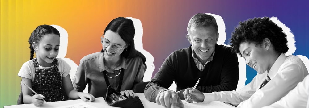 Two educators support learners at a desk