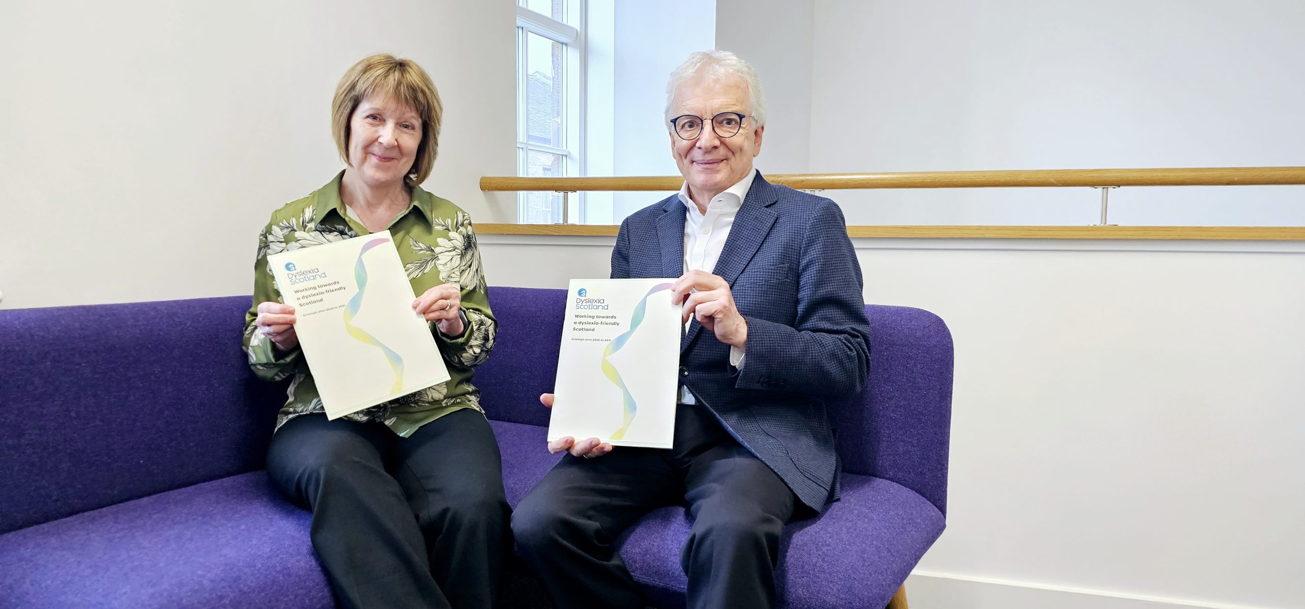 CEO Cathy Magee and Chair Peter Lederer with copies of hte strategy docuent