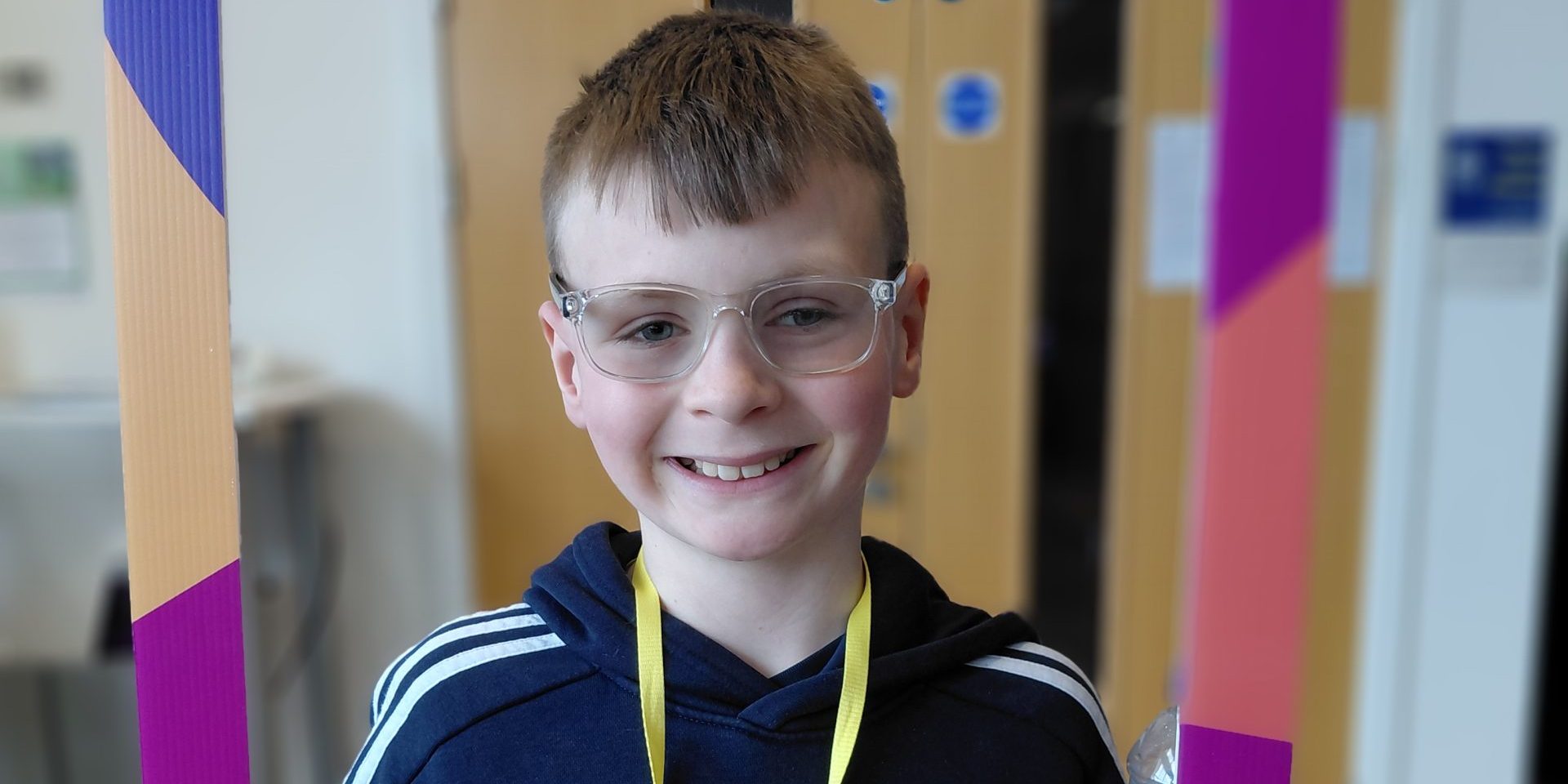 Young man in glasses smiles