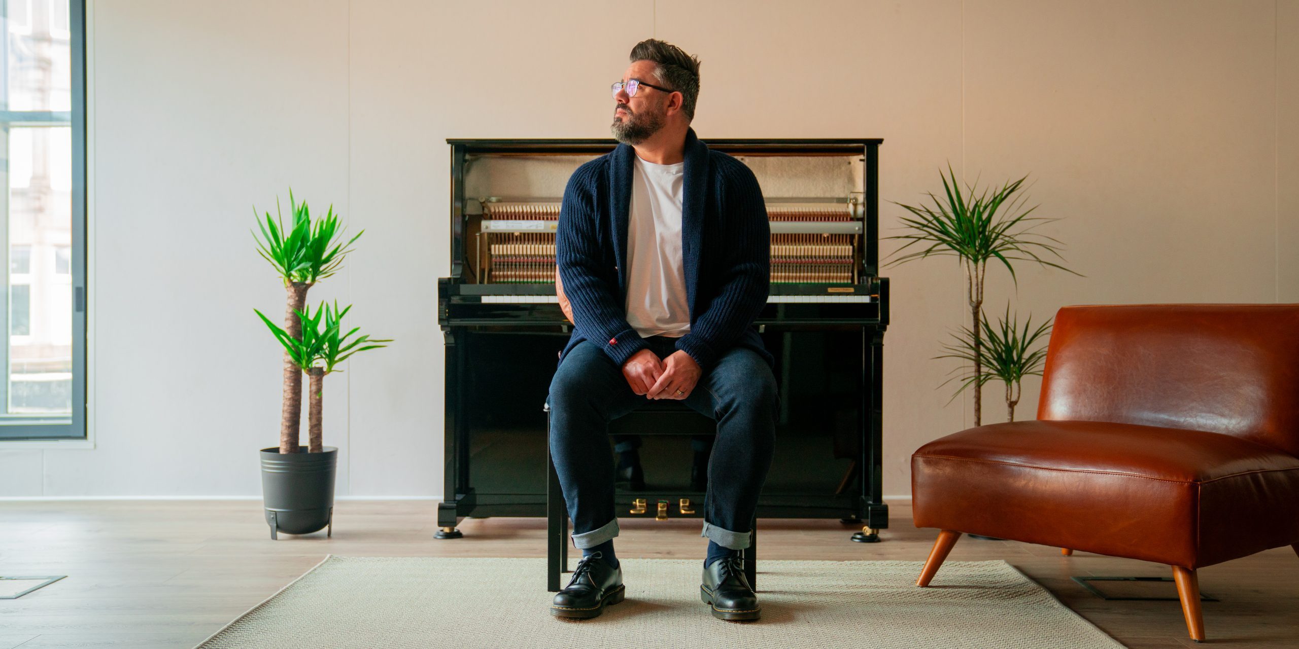 Daniel in front of his piano