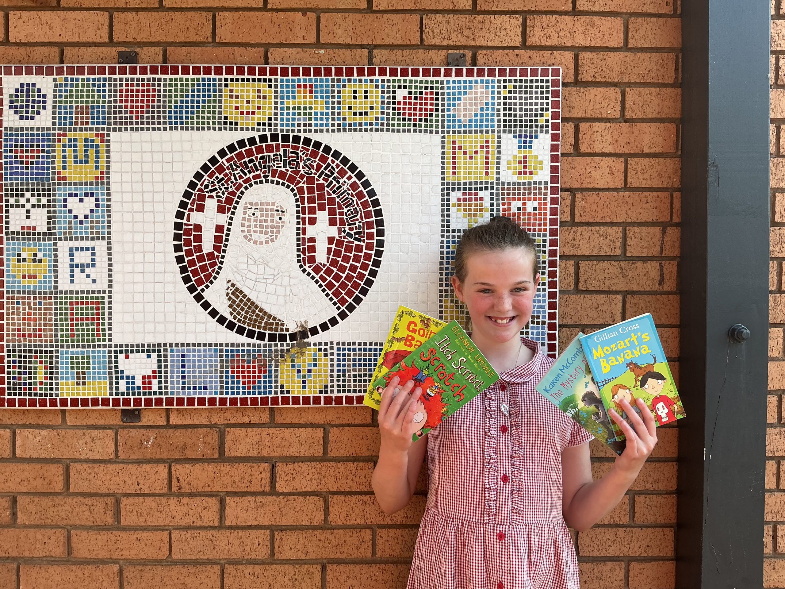 Smiling girl holding books